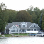 Perspectives Home Designs Gray 2-story home with a view of Glen Lake