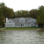 Perspectives Home Designs Gray 2-story home with a view of Glen Lake