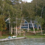 Perspectives Home Designs Blue 2-story home with lakeside view