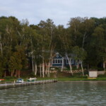 Perspectives Home Designs Blue 2-story home with lakeside view